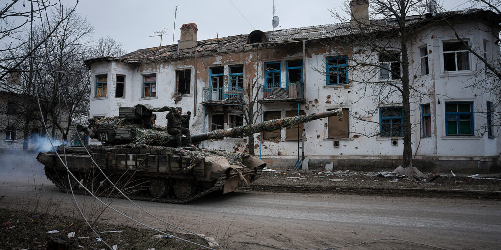 A tank driving down a street
