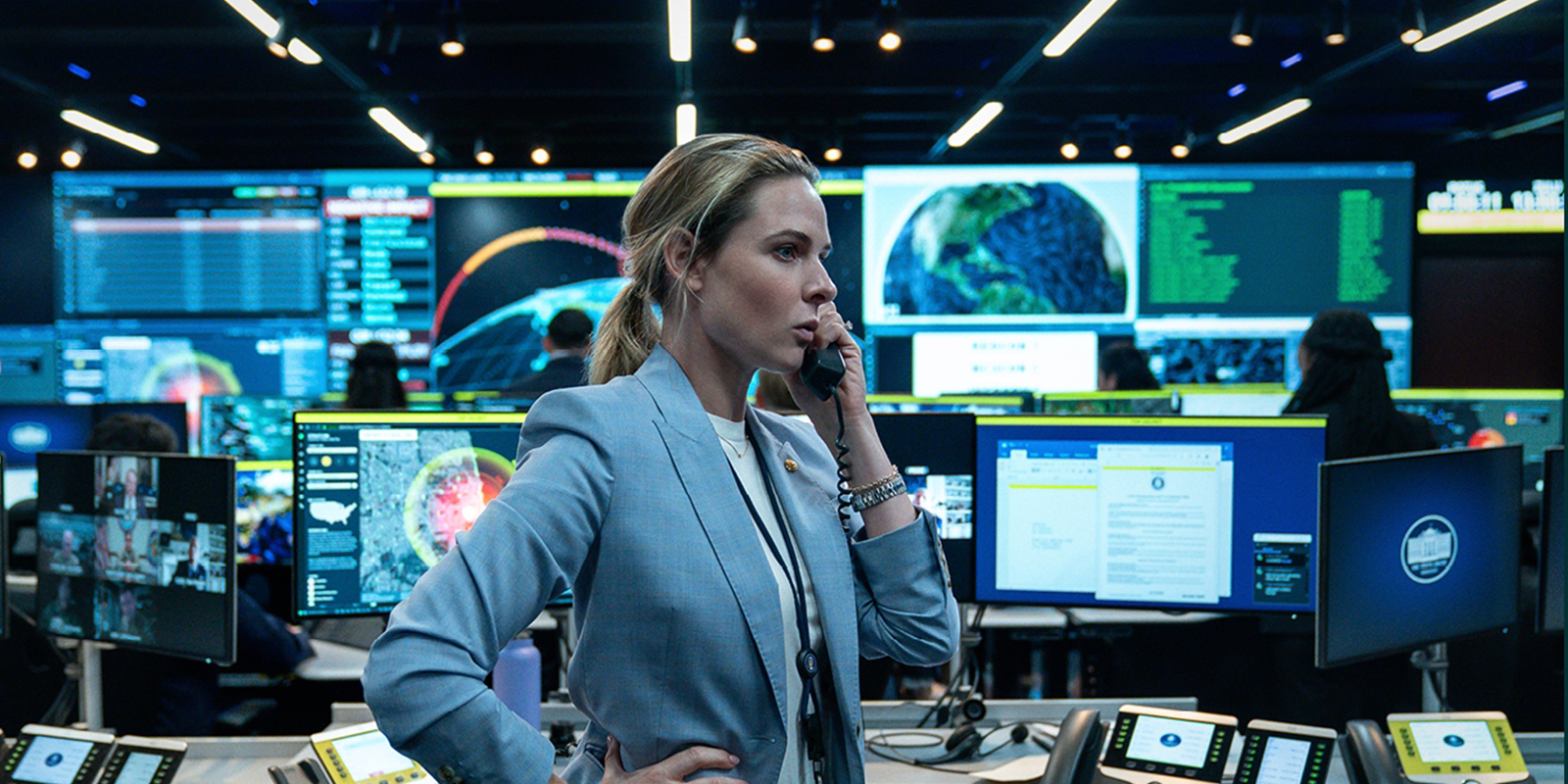 Rebecca Ferguson on the phone in a control room