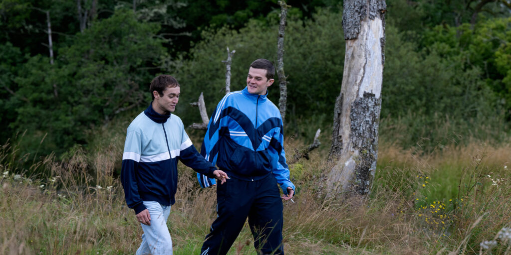 Two men walking through a field