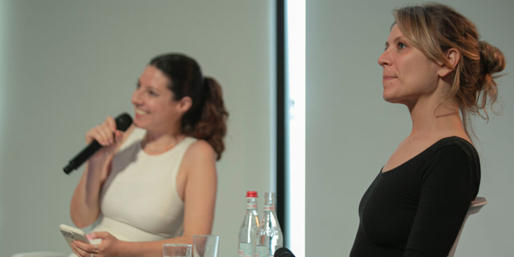 Two women sat on stage 