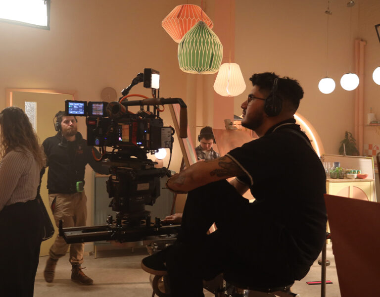 A camera crew on set in a house