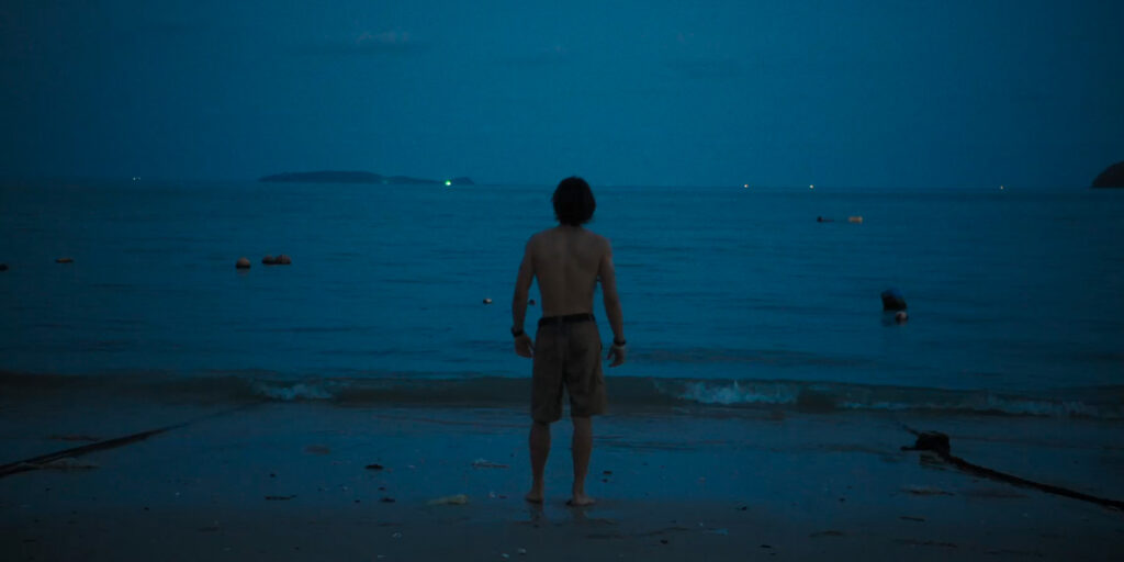A person stood by the sea