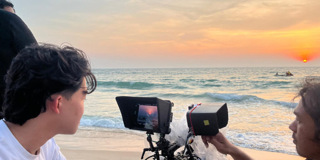 A film crew by the sea