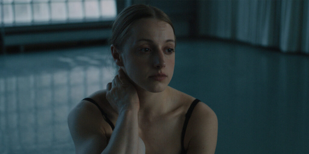 A ballerina sat looking sad