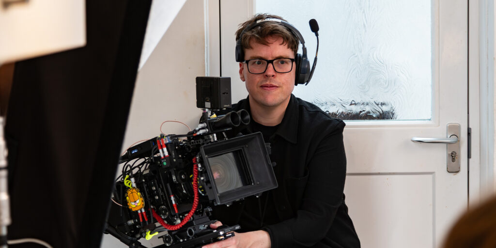 Billy Abbott sitting with a camera