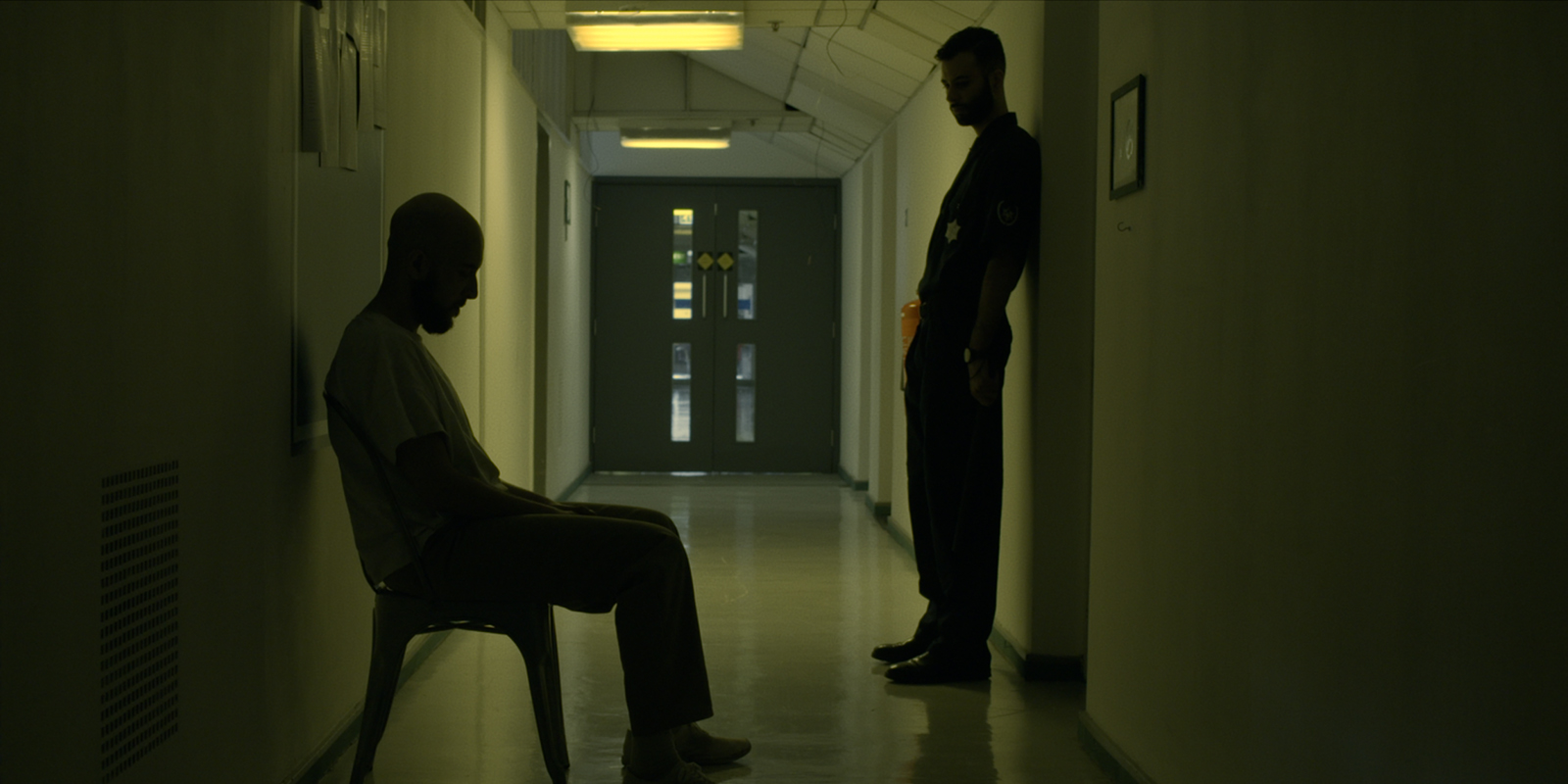 Two people in a dark hallway