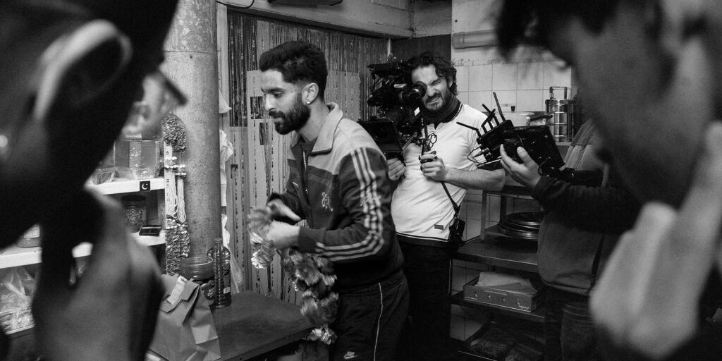 A film crew shooting in a restaurant in a black and white image