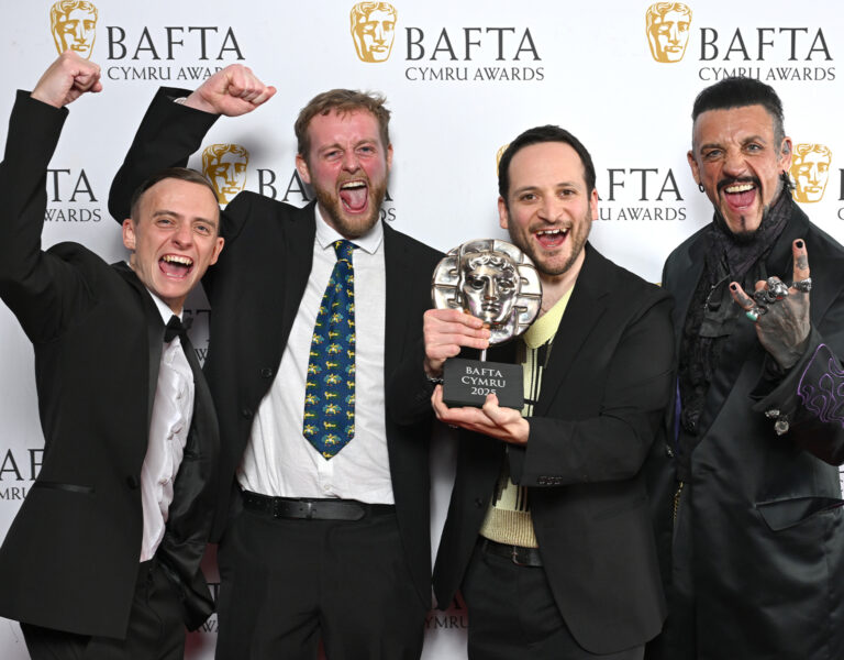 A group of people celebrating an award