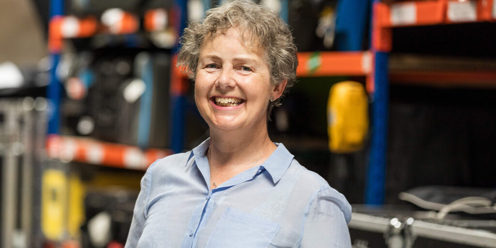 McEnallay smiling in a store cupboard