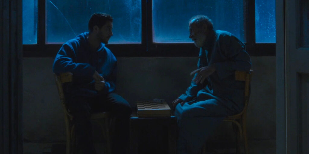 Two men sat in the dark