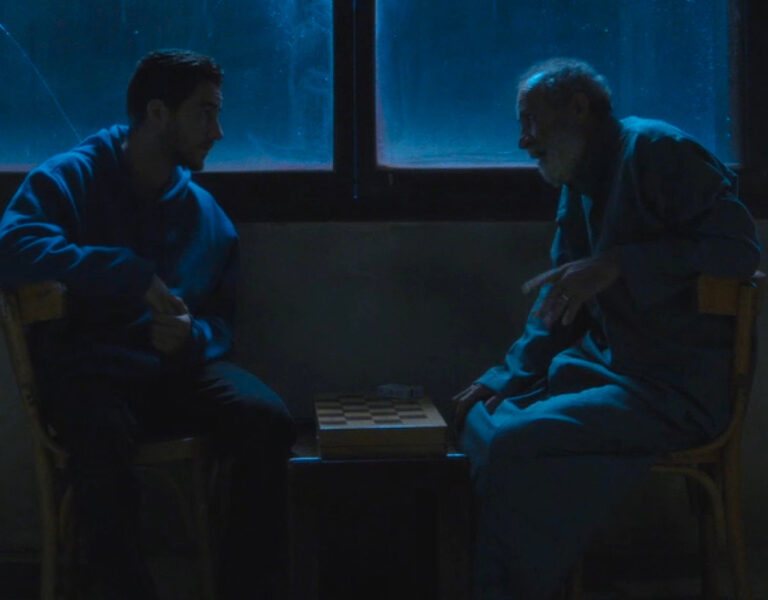 Two men sat in the dark