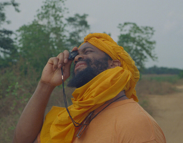 A man in a yellow outfit looking skywards
