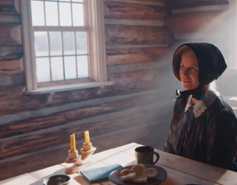A woman sat in period attire