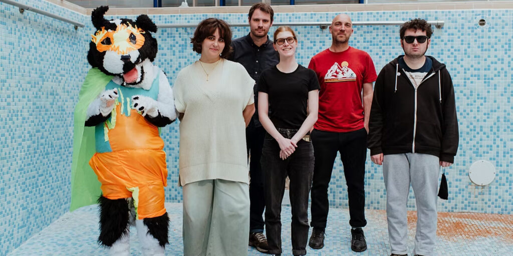 A group of people and a mascot stood together