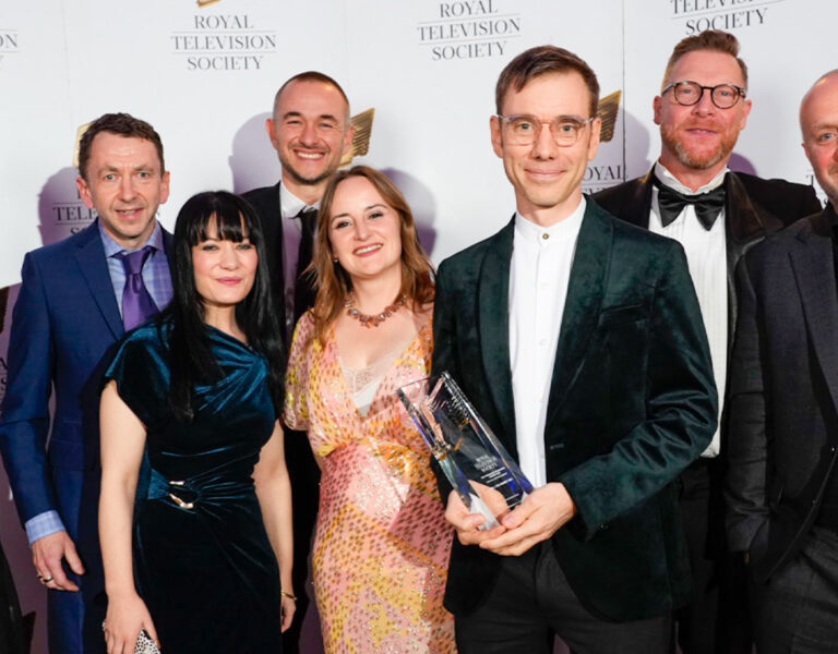 A group of people posing with an award
