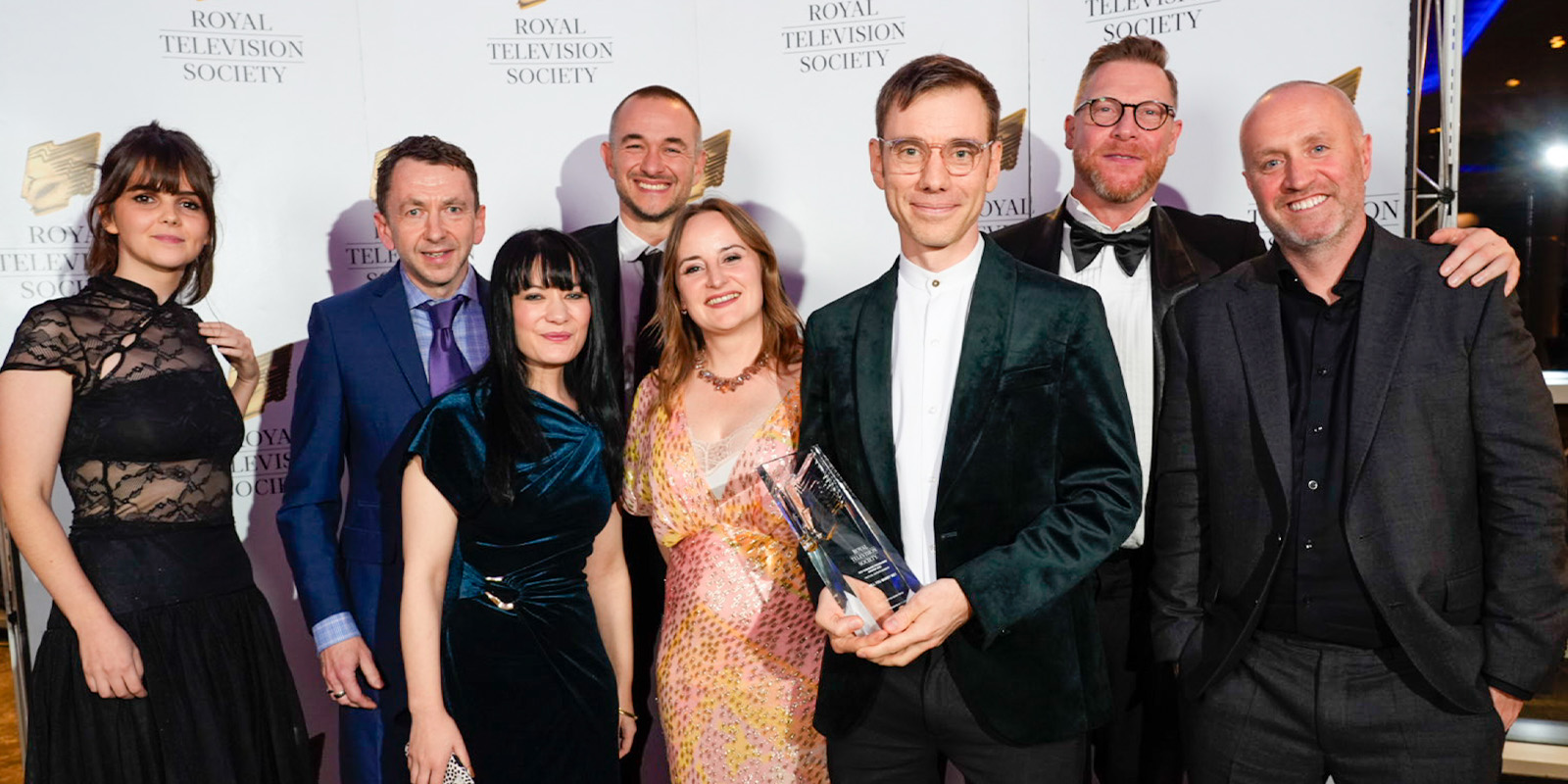 A group of people posing with an award
