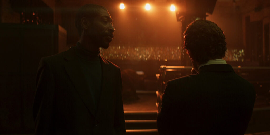 People talking under bright lights