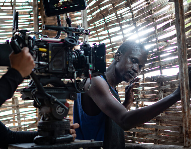 A camera operator filming a person