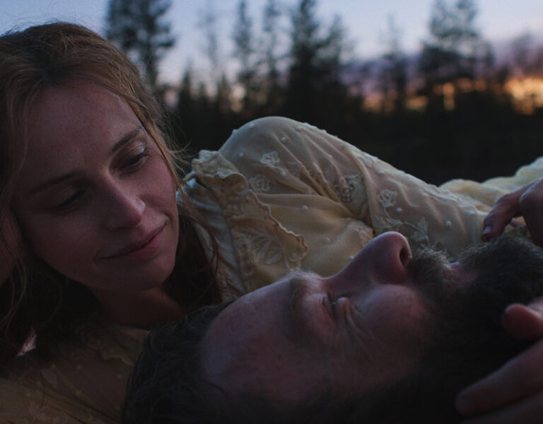 Two people lying together smiling