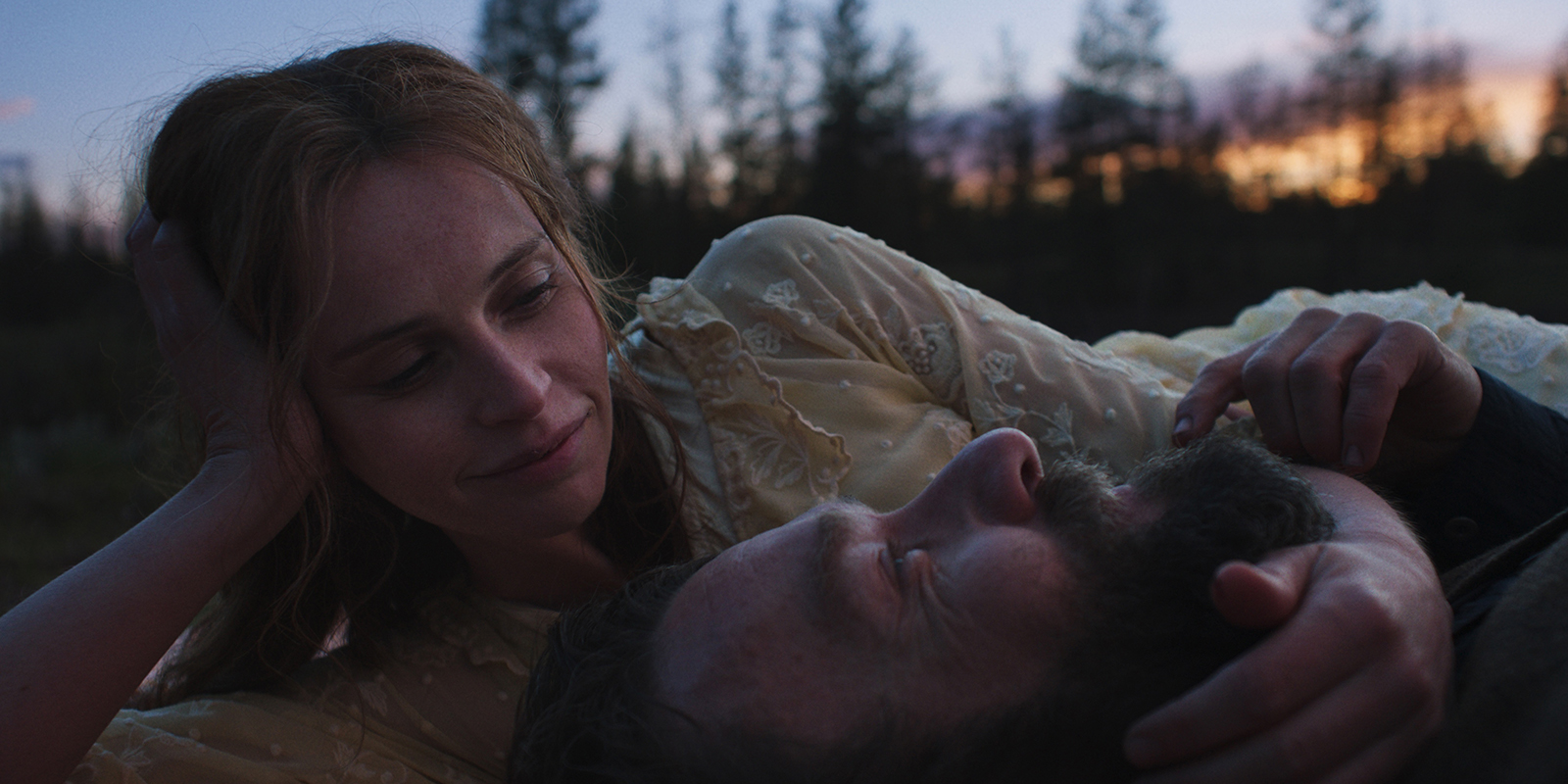 Two people lying together smiling