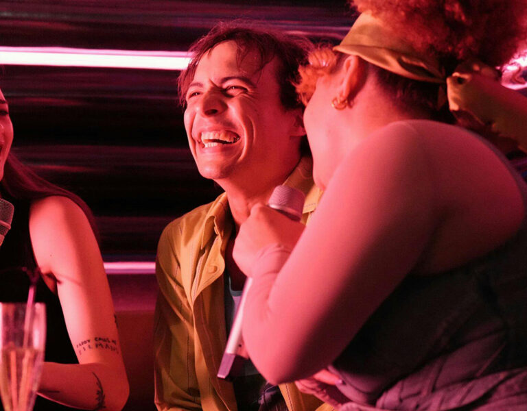 Three people in a club laughing