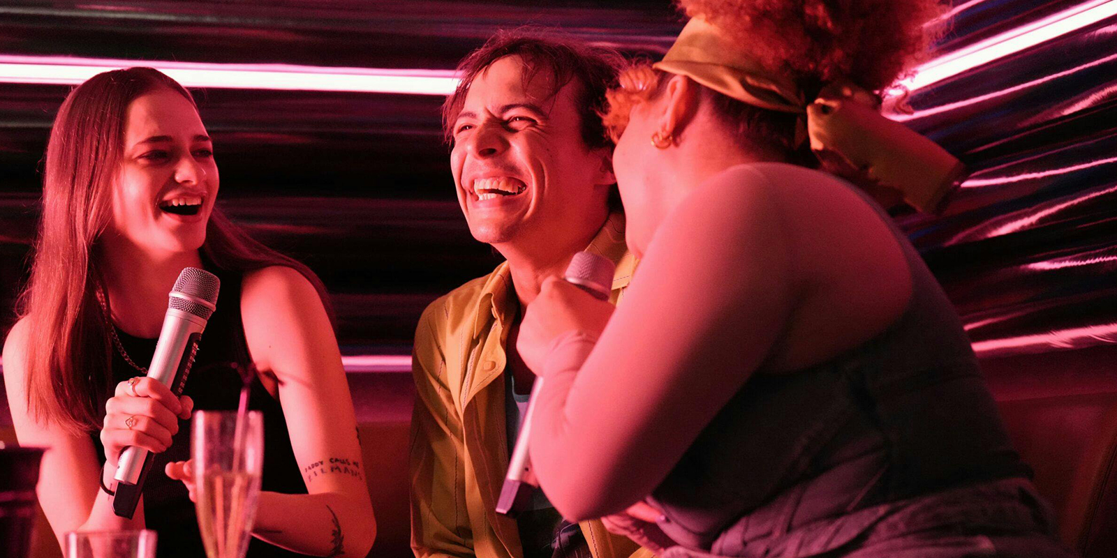 Three people in a club laughing