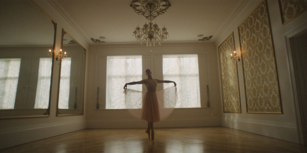 A ballerina in a dancing room 