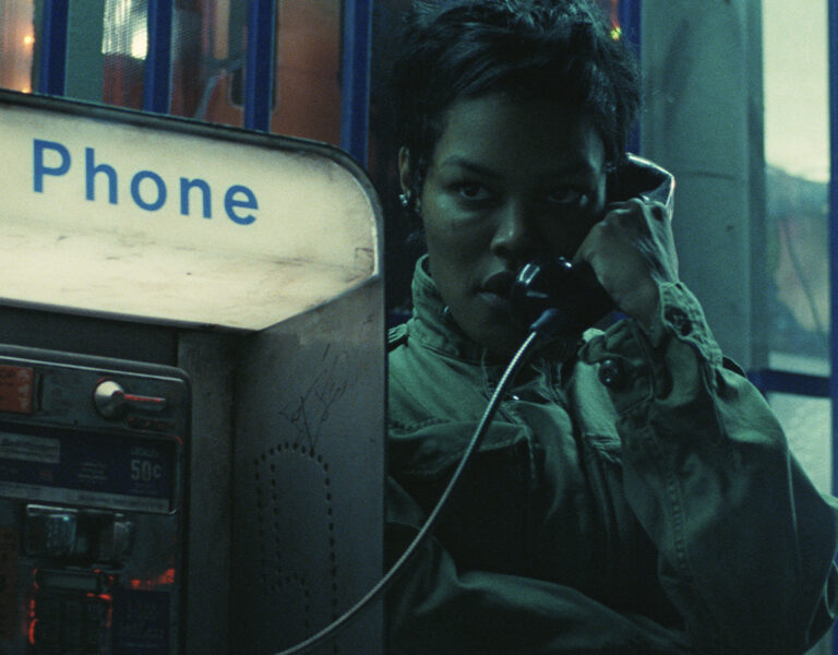 A woman on the phone at a phone booth