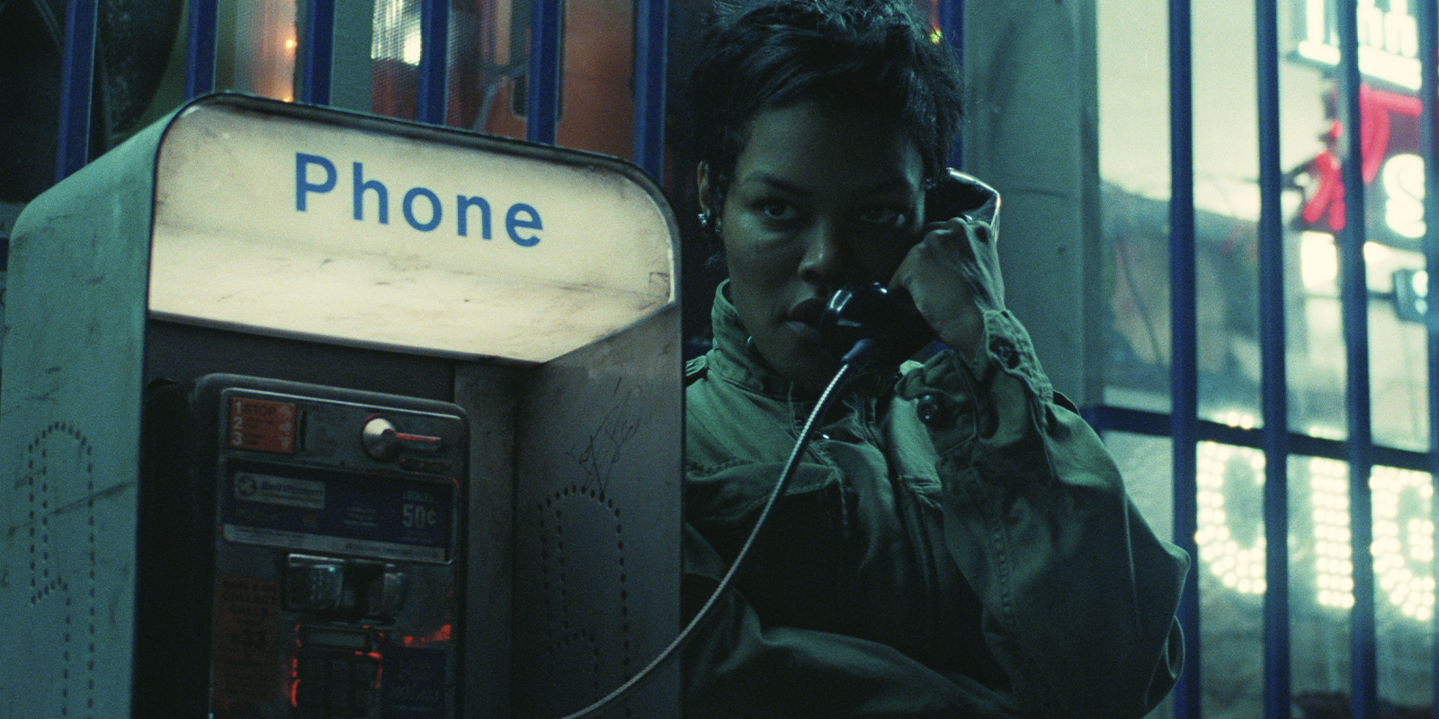A woman on the phone at a phone booth