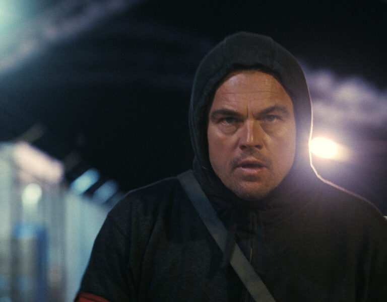 Leonardo Dicaprio in a black hoodie walking