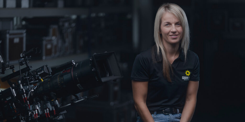 A woman sat smiling in a Sunbelt Rentals uniform