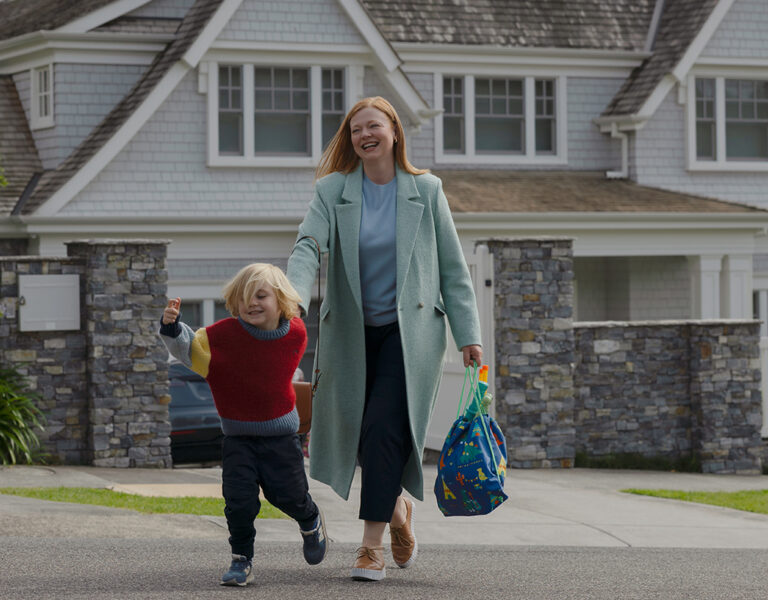 A mother and child walk down a street
