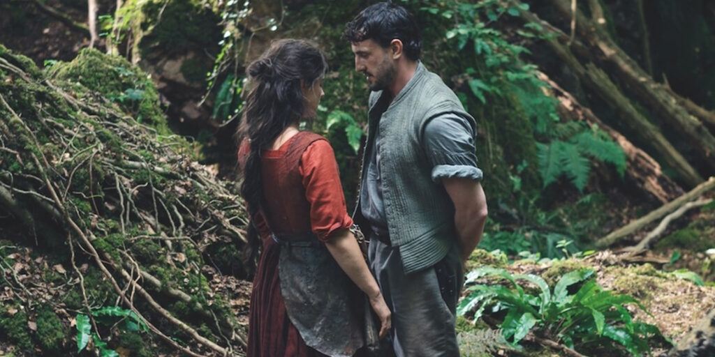 Two people stood in the woods