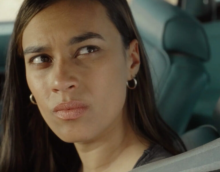 A woman sat in the car, scowling