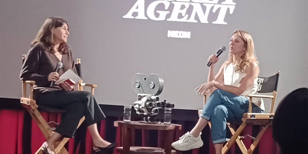 Two women sat on stage walking