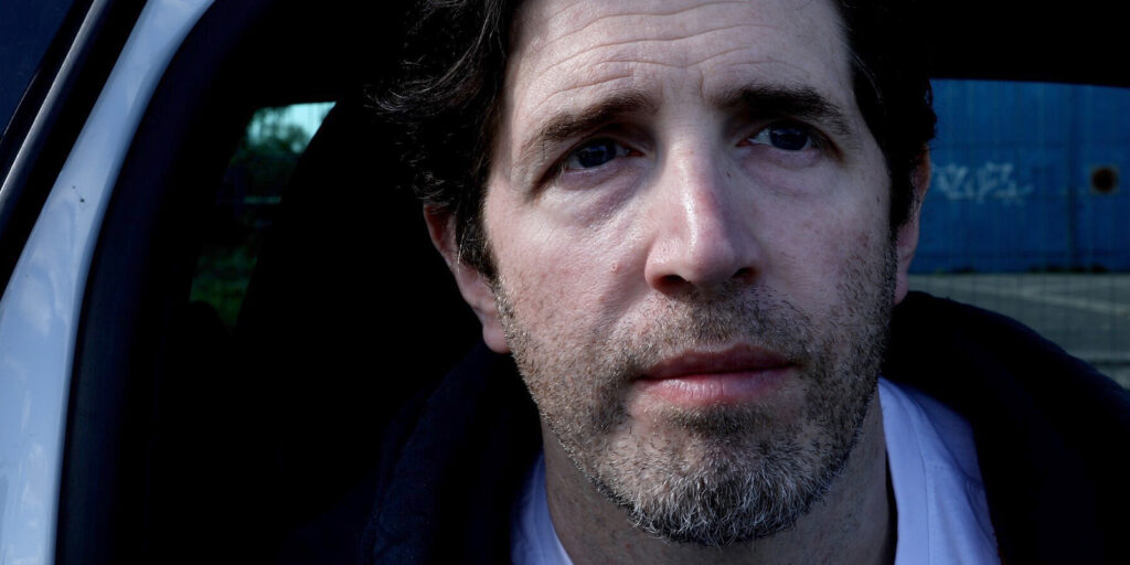 A man sat in a car