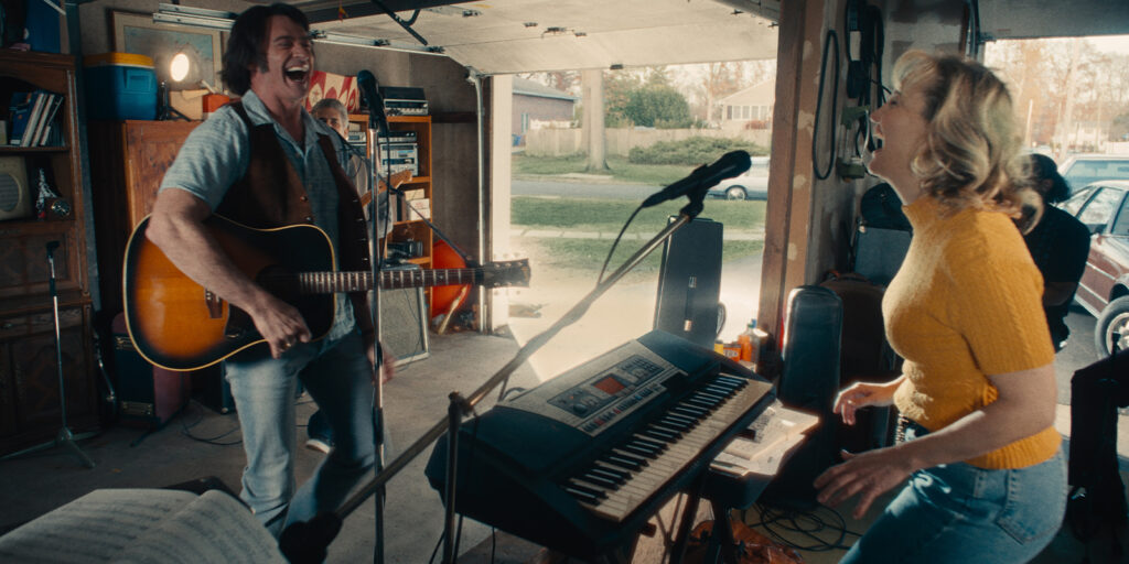 Two people singing in their garage