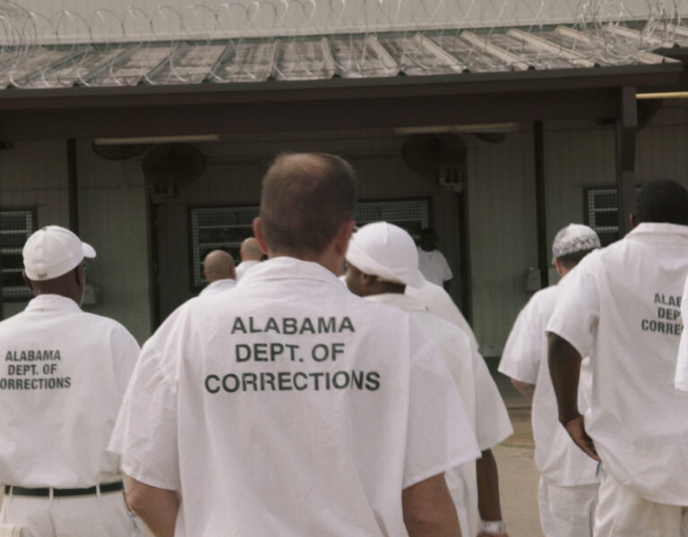 Prisoners walking in white outfits