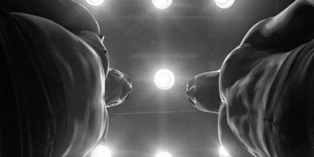 Two wrestlers staring each other down