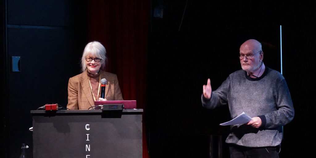 Two people stood on stage