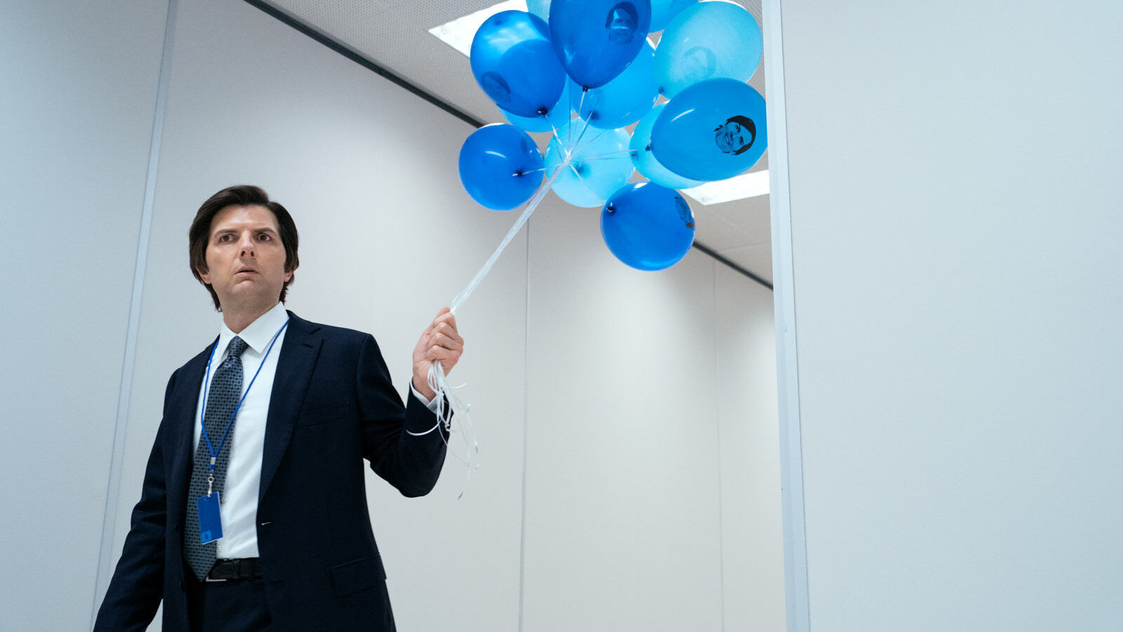 Adam Scott walking with blue balloons