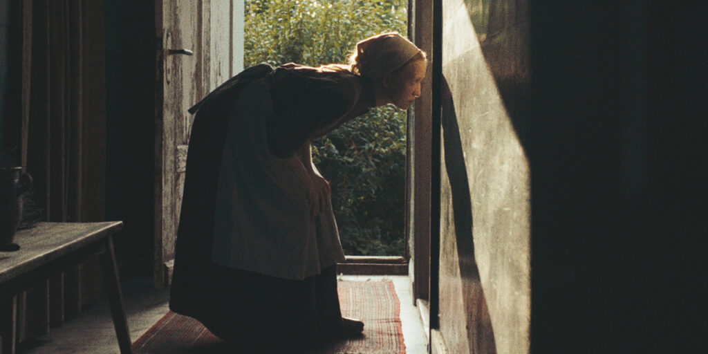 A woman looking through a keyhole