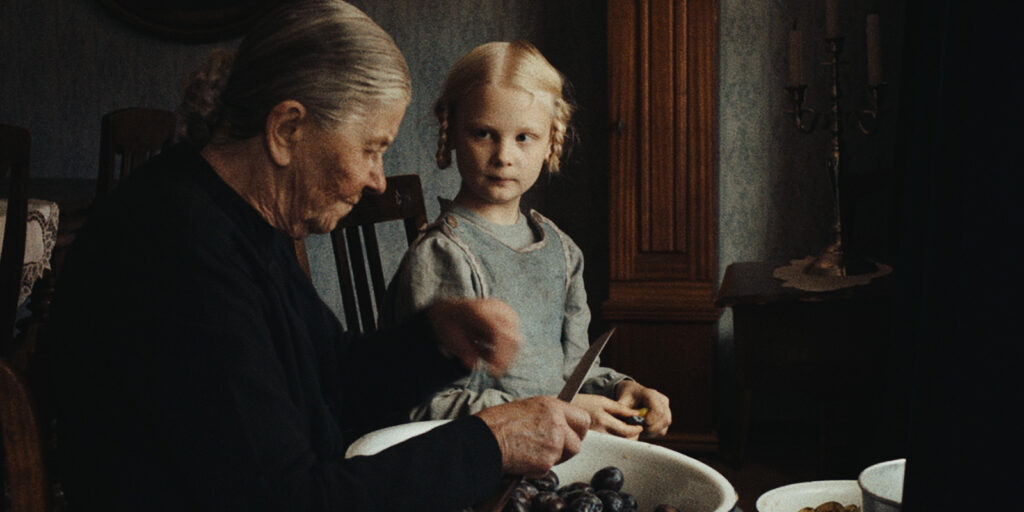 A girl looking at an older lady