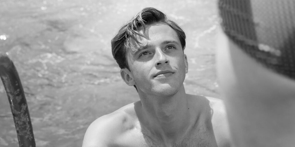 A man smiling looking up
