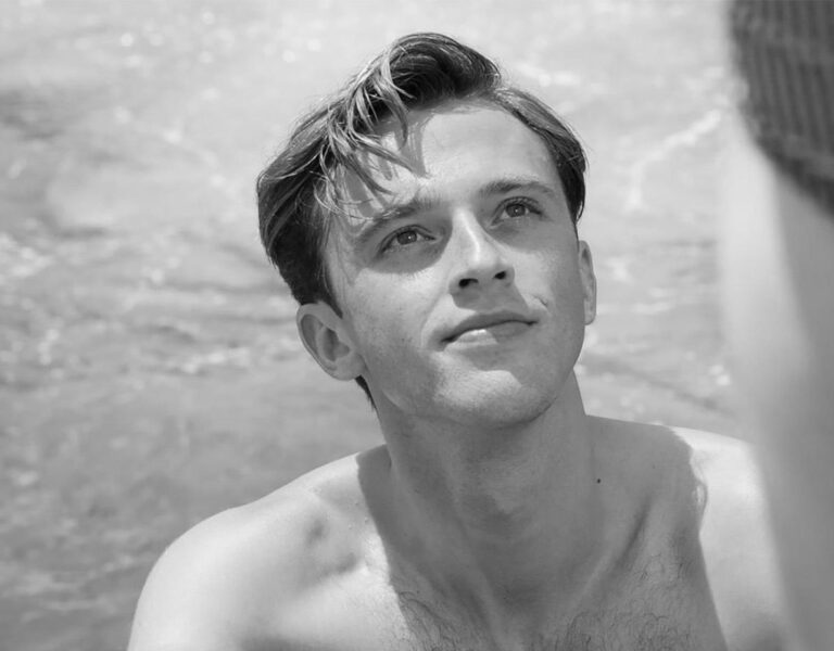 A man smiling looking up