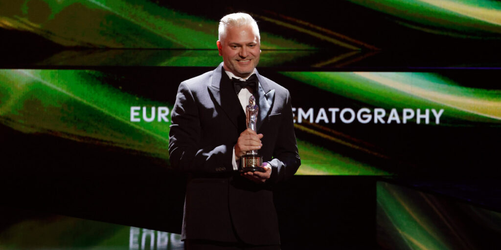 Ben Kracun on stage with an award