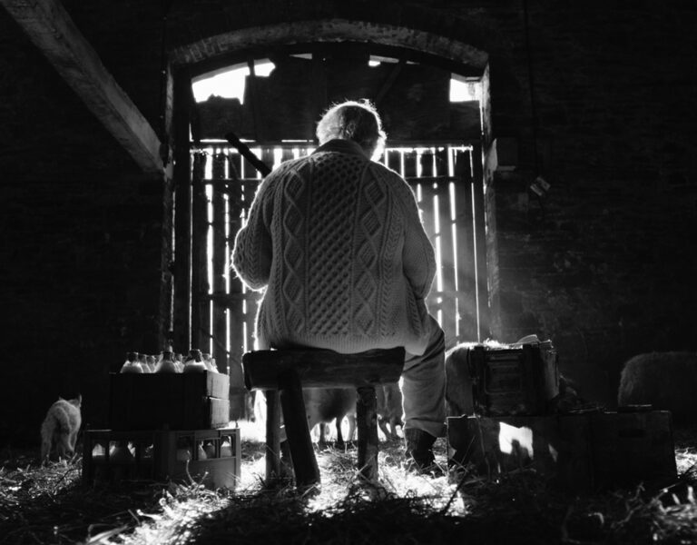 A man sat in a barn