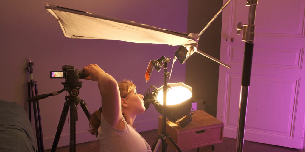 A person setting up lighting for a shot