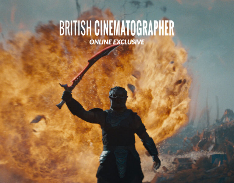 A person in dark armour holds a sword overhead whilst standing before a fiery explosion. The words BRITISH CINEMATOGRAPHER ONLINE EXCLUSIVE appear at the top, highlighting Jeff Cutter's work on Predator: Badlands.