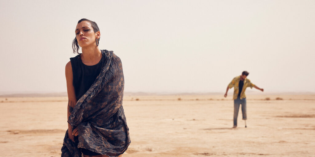 Two people standing in the desert